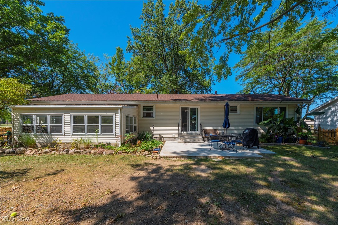 3615 Kolbe Road Lorain, OH 44053 - Photo 27 of 33 Rear view of property featuring a patio area and a lawn