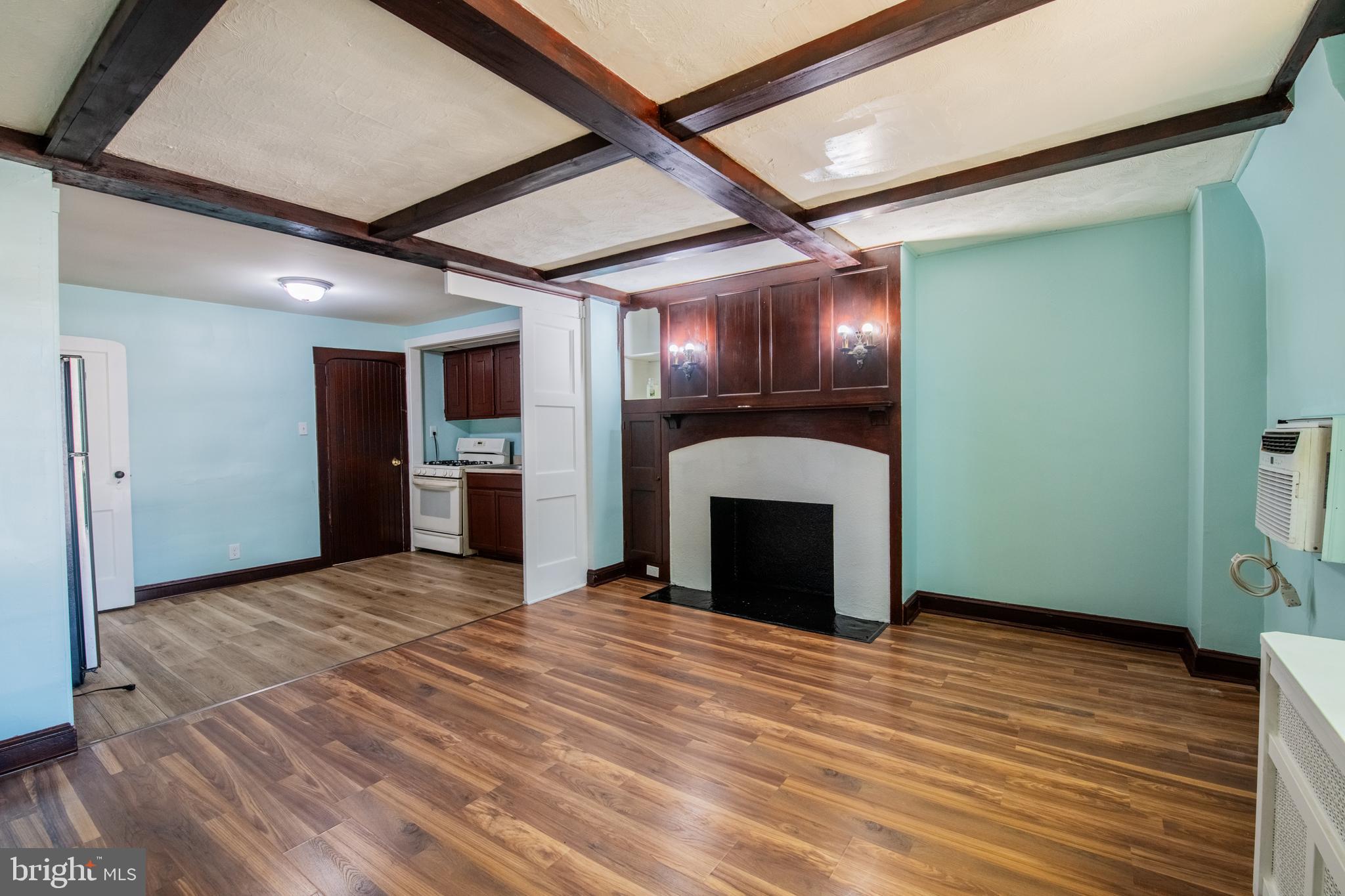 309 Hampden Road Upper Darby, PA 19082 - Photo 13 of 19 a view of an empty room with wooden floor and a kitchen