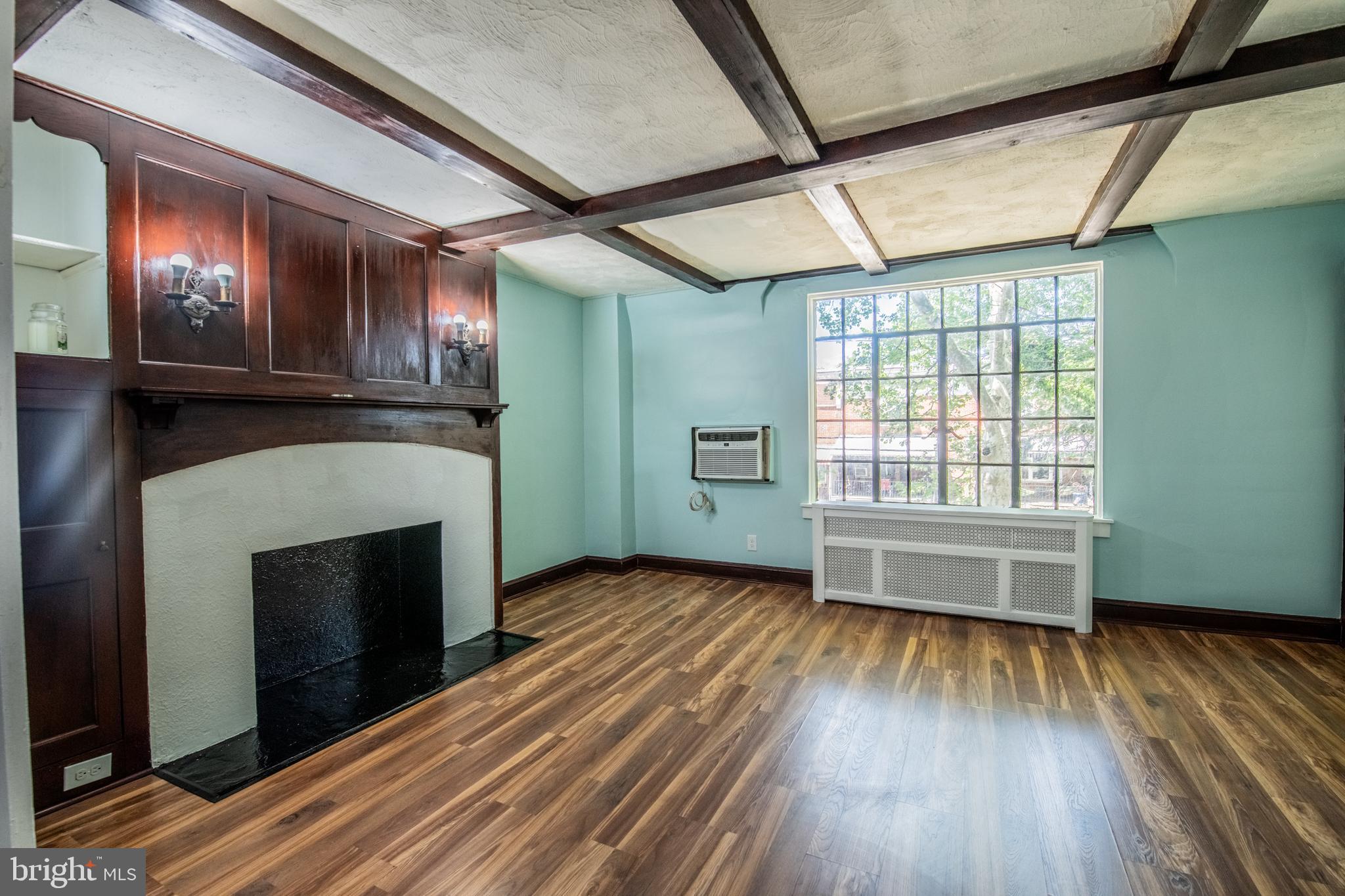 309 Hampden Road Upper Darby, PA 19082 - Photo 14 of 19 a view of an empty room with wooden floor fireplace and a window