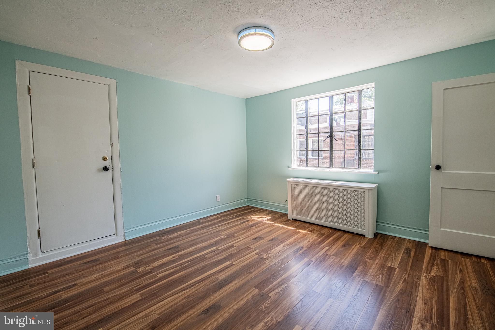 309 Hampden Road Upper Darby, PA 19082 - Photo 18 of 19 an empty room with wooden floor and windows