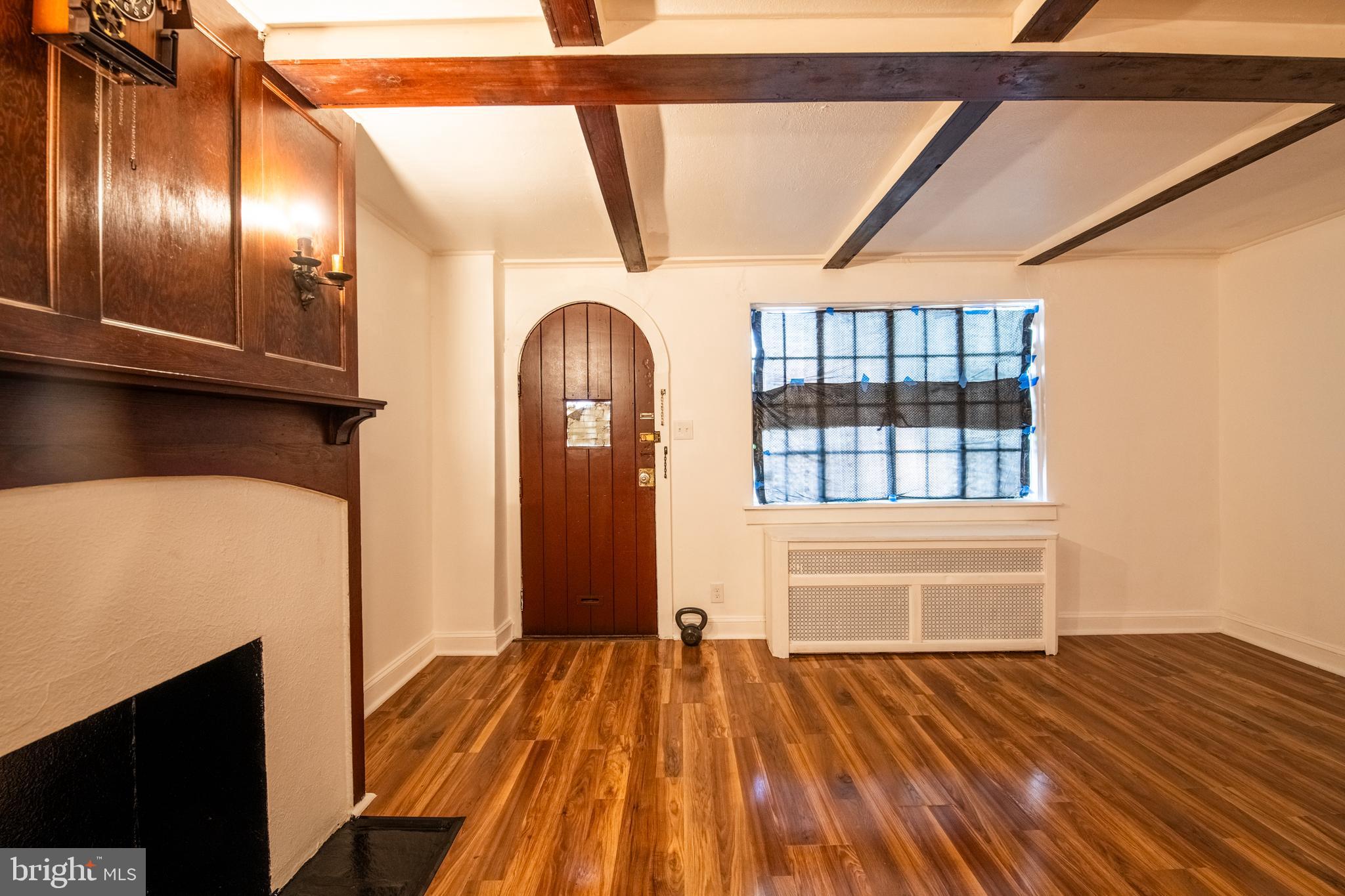 309 Hampden Road Upper Darby, PA 19082 - Photo 2 of 19 a view of an empty room with wooden floor and windows