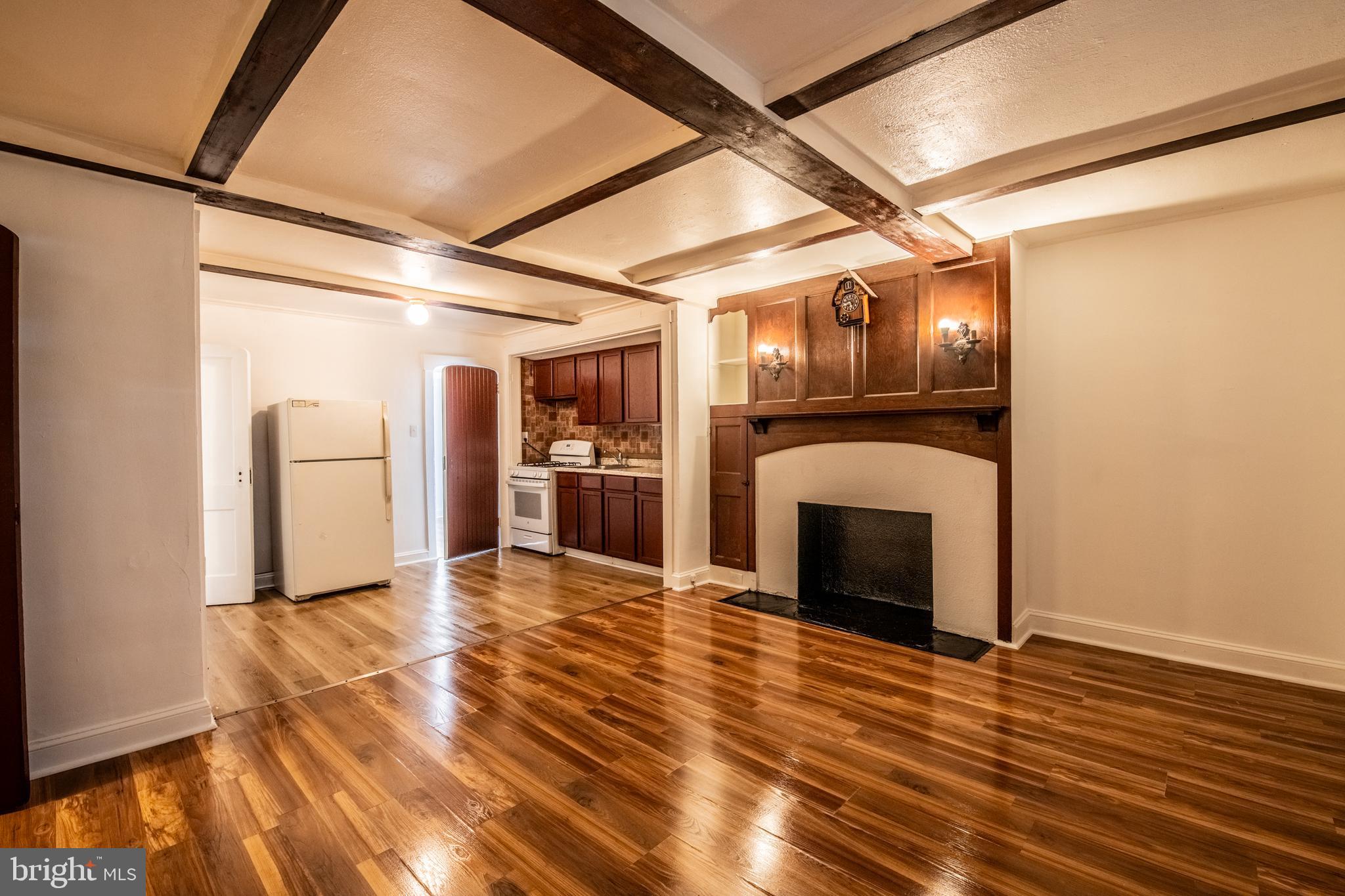 309 Hampden Road Upper Darby, PA 19082 - Photo 3 of 19 a view of empty room with wooden floor and fireplace