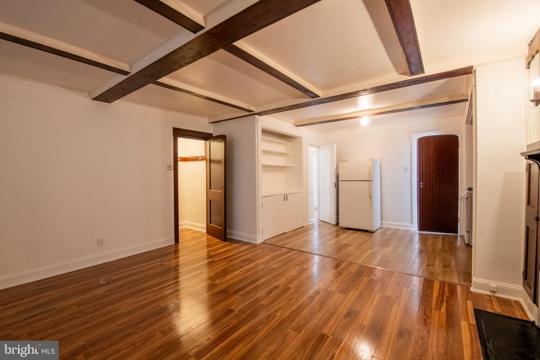 309 Hampden Road Upper Darby, PA 19082 - Photo 4 of 19 a view of an empty room with wooden floor and a window