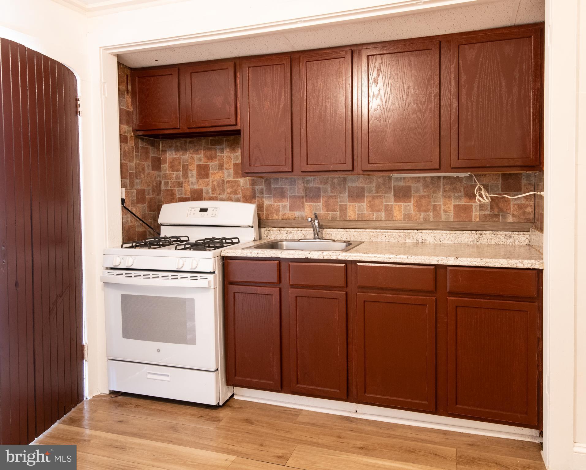 309 Hampden Road Upper Darby, PA 19082 - Photo 6 of 19 a kitchen with a sink and a stove top oven