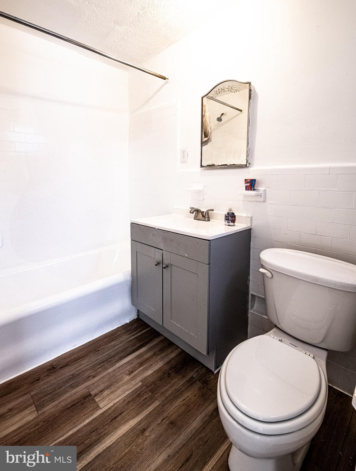 309 Hampden Road Upper Darby, PA 19082 - Photo 9 of 19 a bathroom with a toilet a sink and mirror