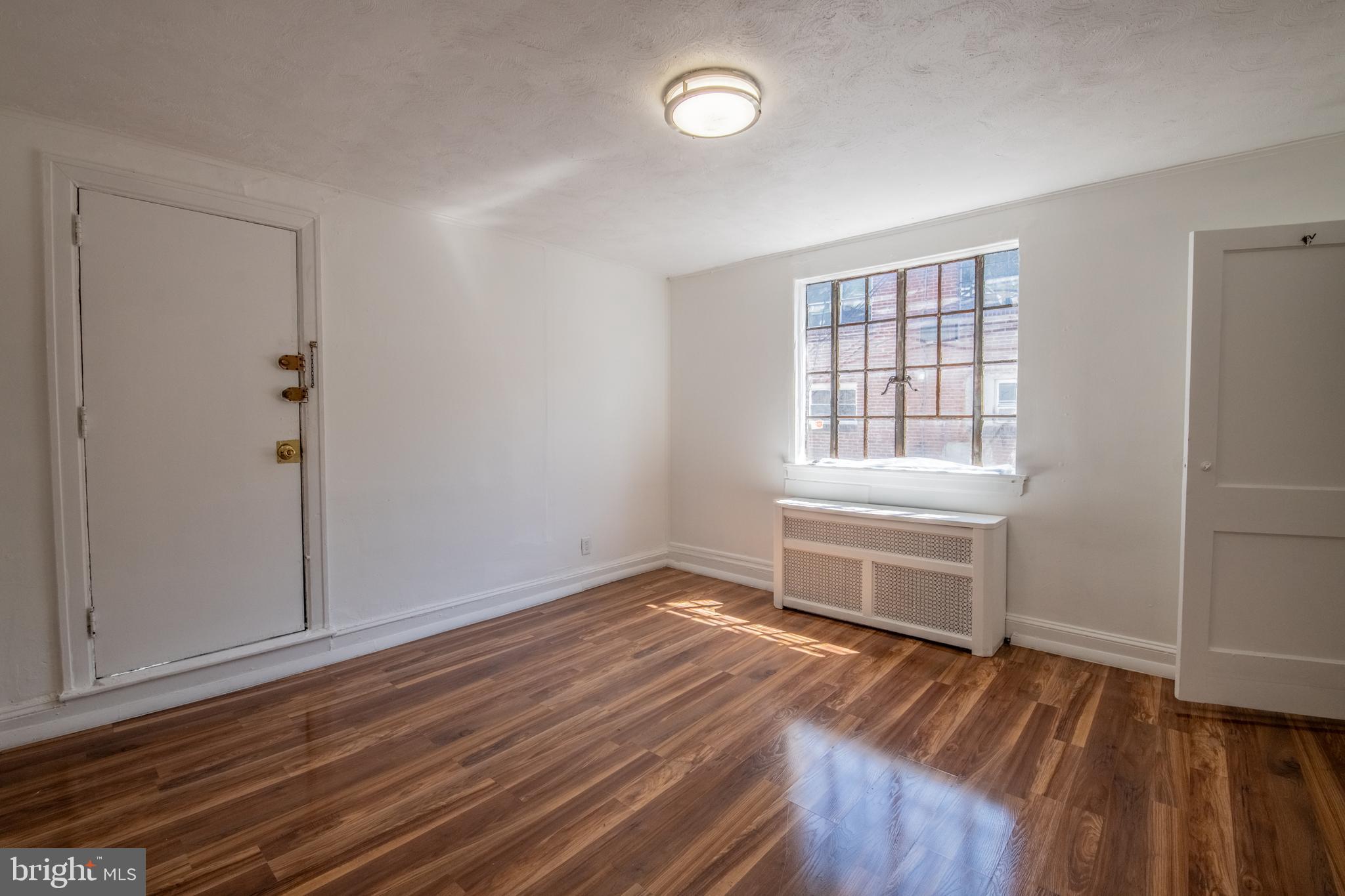 309 Hampden Road Upper Darby, PA 19082 - Photo 10 of 19 an empty room with wooden floor and windows
