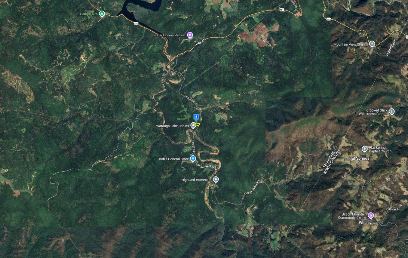 480 Poga Road Butler, TN 37640 - Photo 4 of 5 a backyard of a house with lots of green space and a lake view