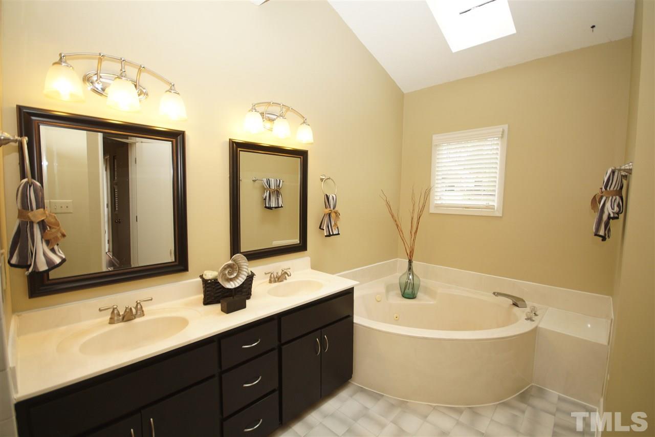 4100 Landfall Court Raleigh, NC 27613 - Photo 12 of 20 a bathroom with a tub double sink and mirror