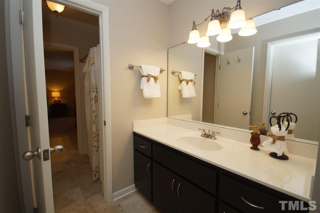 4100 Landfall Court Raleigh, NC 27613 - Photo 15 of 20 a bathroom with a sink vanity and a mirror