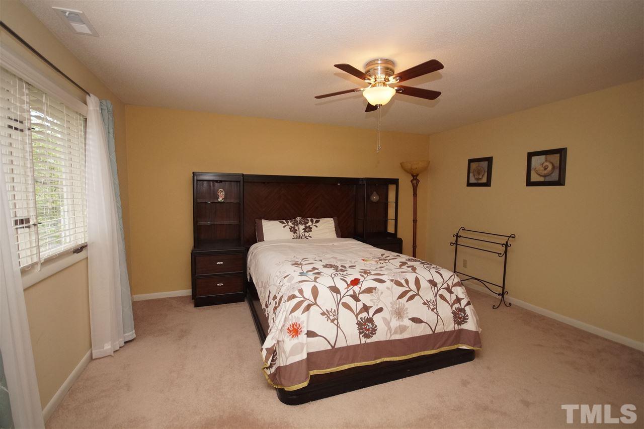 4100 Landfall Court Raleigh, NC 27613 - Photo 16 of 20 a bedroom with a bed and window