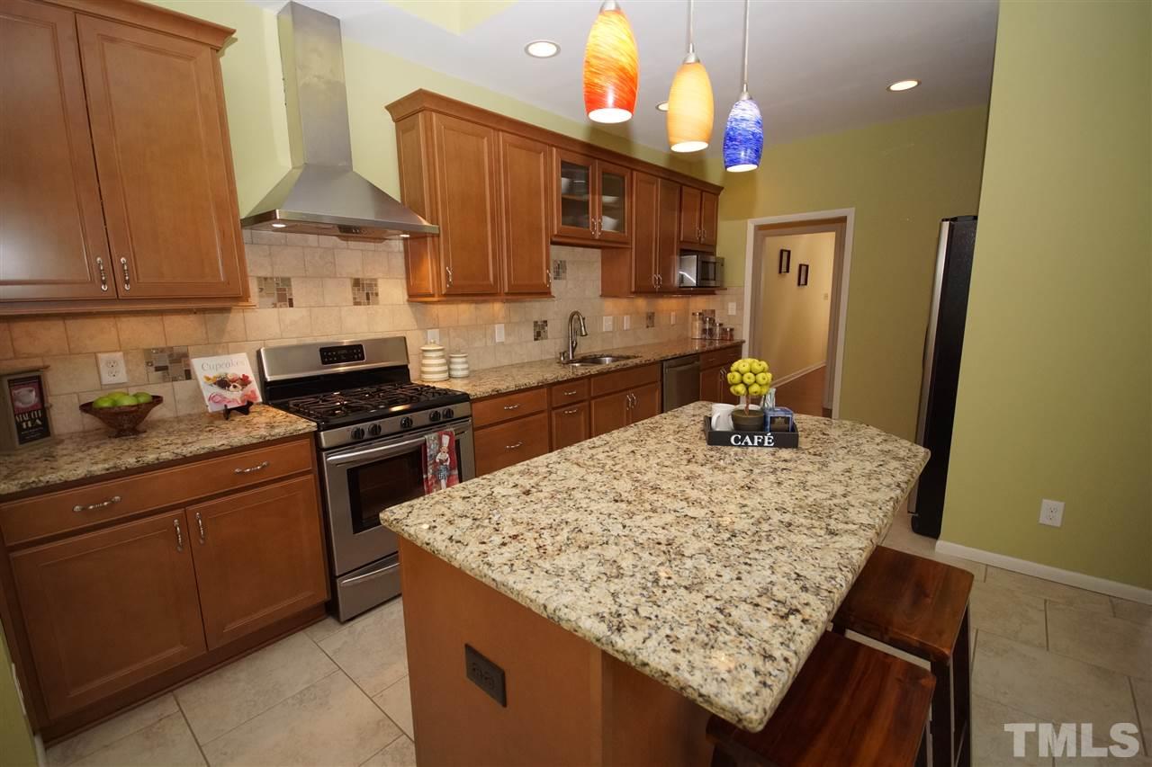 4100 Landfall Court Raleigh, NC 27613 - Photo 8 of 20 a kitchen with a sink appliances and cabinets
