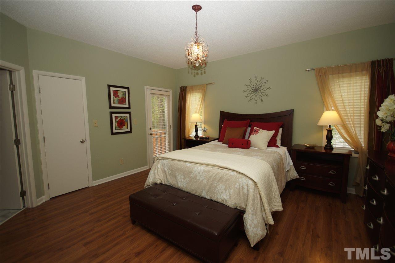4100 Landfall Court Raleigh, NC 27613 - Photo 10 of 20 a bedroom with a bed and wooden floor