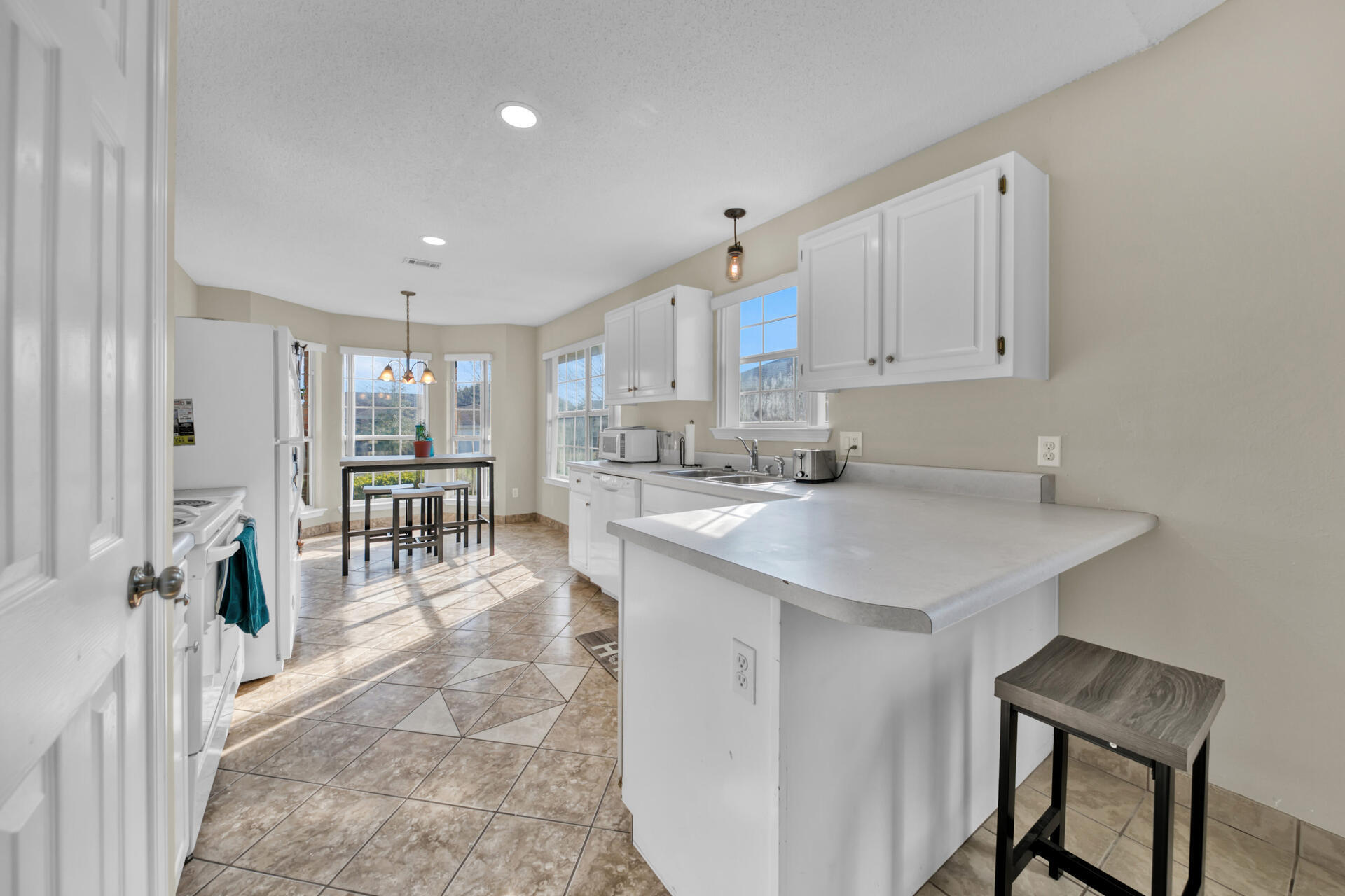 2837 Atoka Trail Crestview, FL 32539 - Photo 11 of 28 a kitchen with counter and chairs