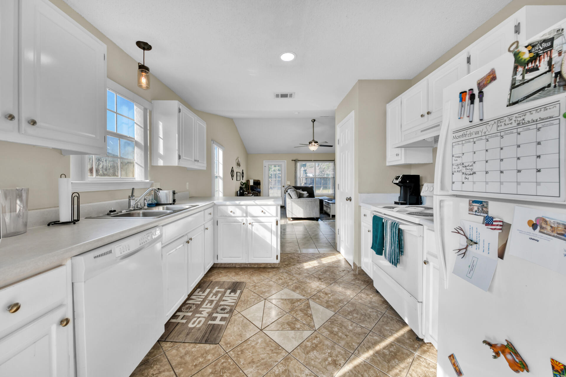 2837 Atoka Trail Crestview, FL 32539 - Photo 14 of 28 a large white kitchen with stainless steel appliances granite countertop a sink and cabinets
