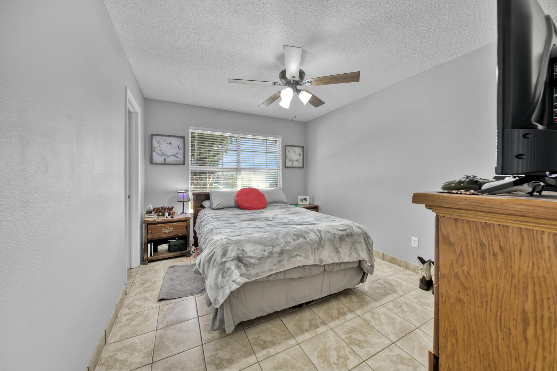 2837 Atoka Trail Crestview, FL 32539 - Photo 16 of 28 a bedroom with a bed and a flat screen tv