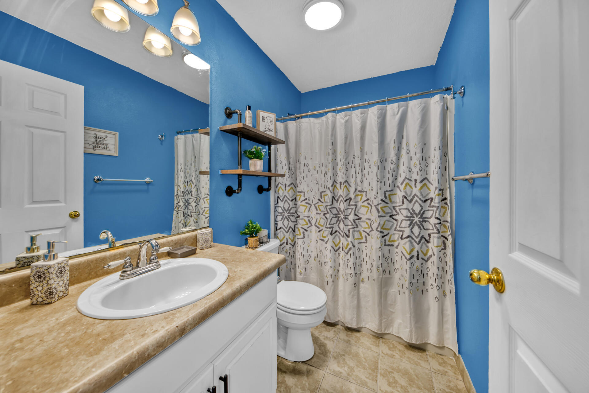 2837 Atoka Trail Crestview, FL 32539 - Photo 18 of 28 a bathroom with a granite countertop sink toilet a mirror and shower curtain