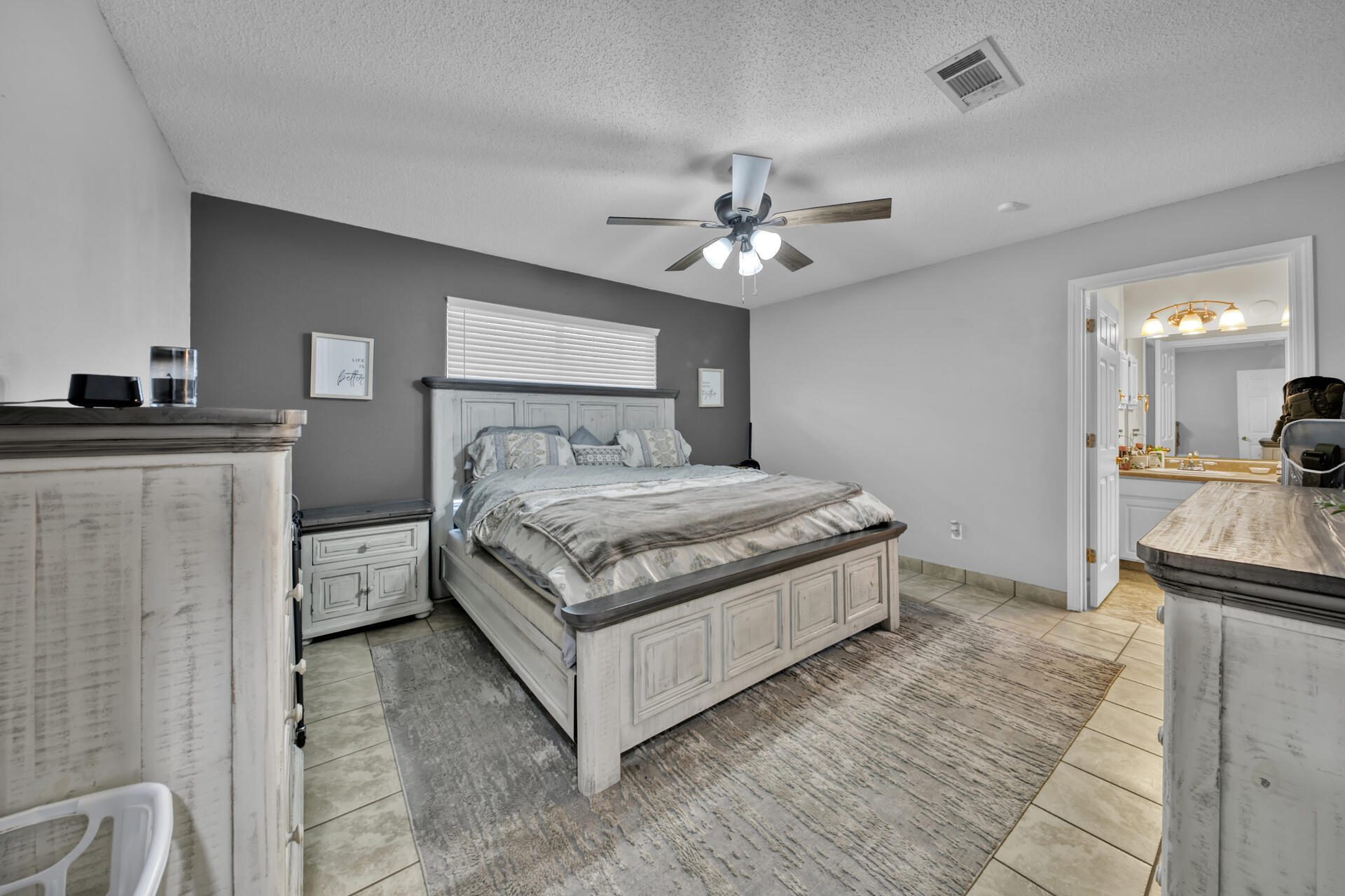 2837 Atoka Trail Crestview, FL 32539 - Photo 21 of 28 a spacious bedroom with a bed and a chandelier