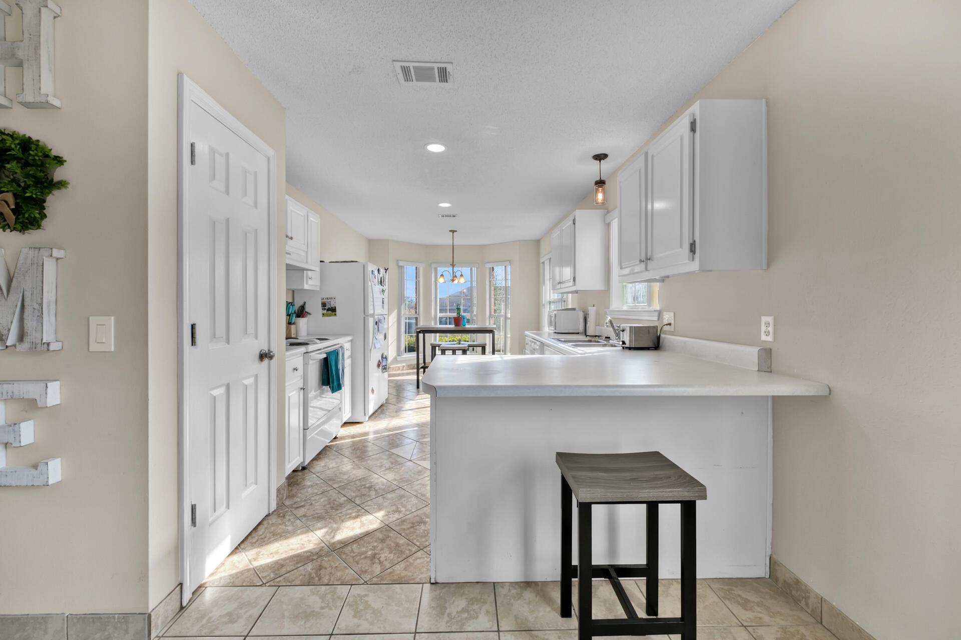 2837 Atoka Trail Crestview, FL 32539 - Photo 9 of 28 a kitchen with stainless steel appliances a sink stove and cabinets
