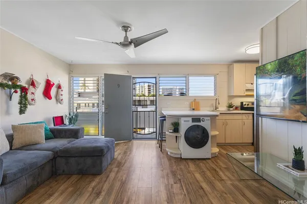 a living room with furniture and a wooden floor