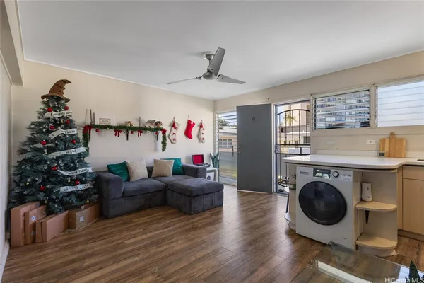 a living room with furniture a flat screen tv and a floor to ceiling window