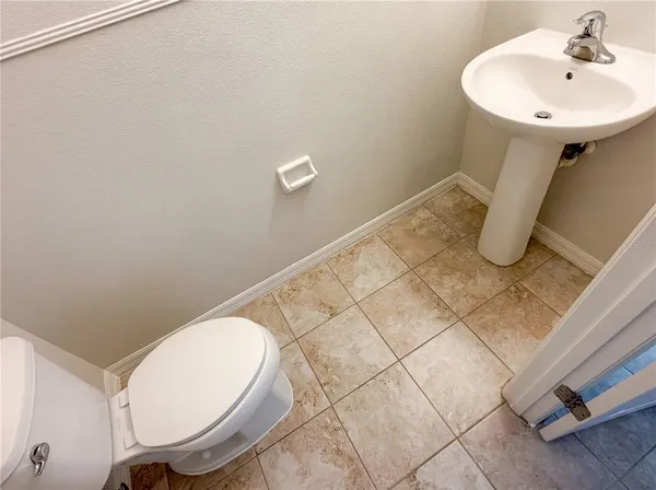 a bathroom with a sink toilet and mirror