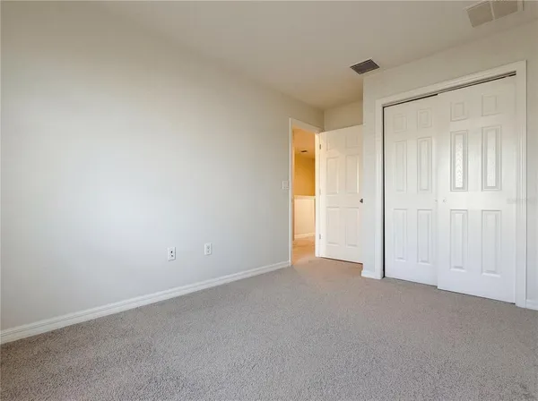 a view of an empty room and closet area
