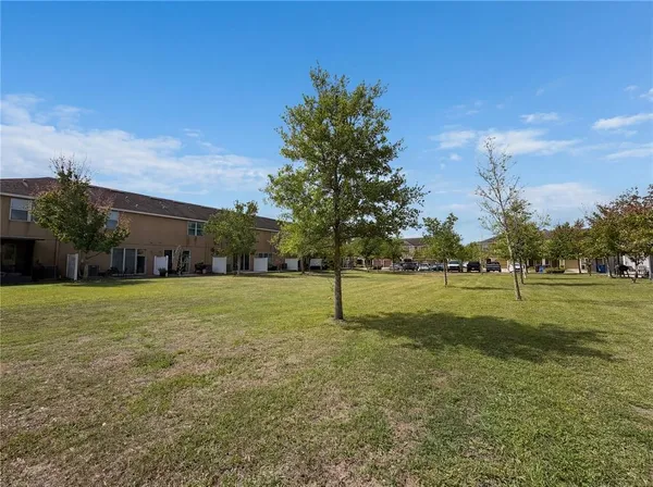 a swimming pool with outdoor seating and yard