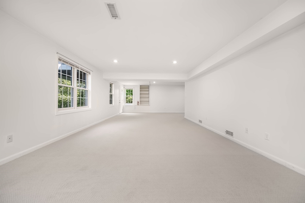 128 Audubon Drive, Unit 128 Acton, MA 01720 - Photo 22 of 42 an empty room with windows