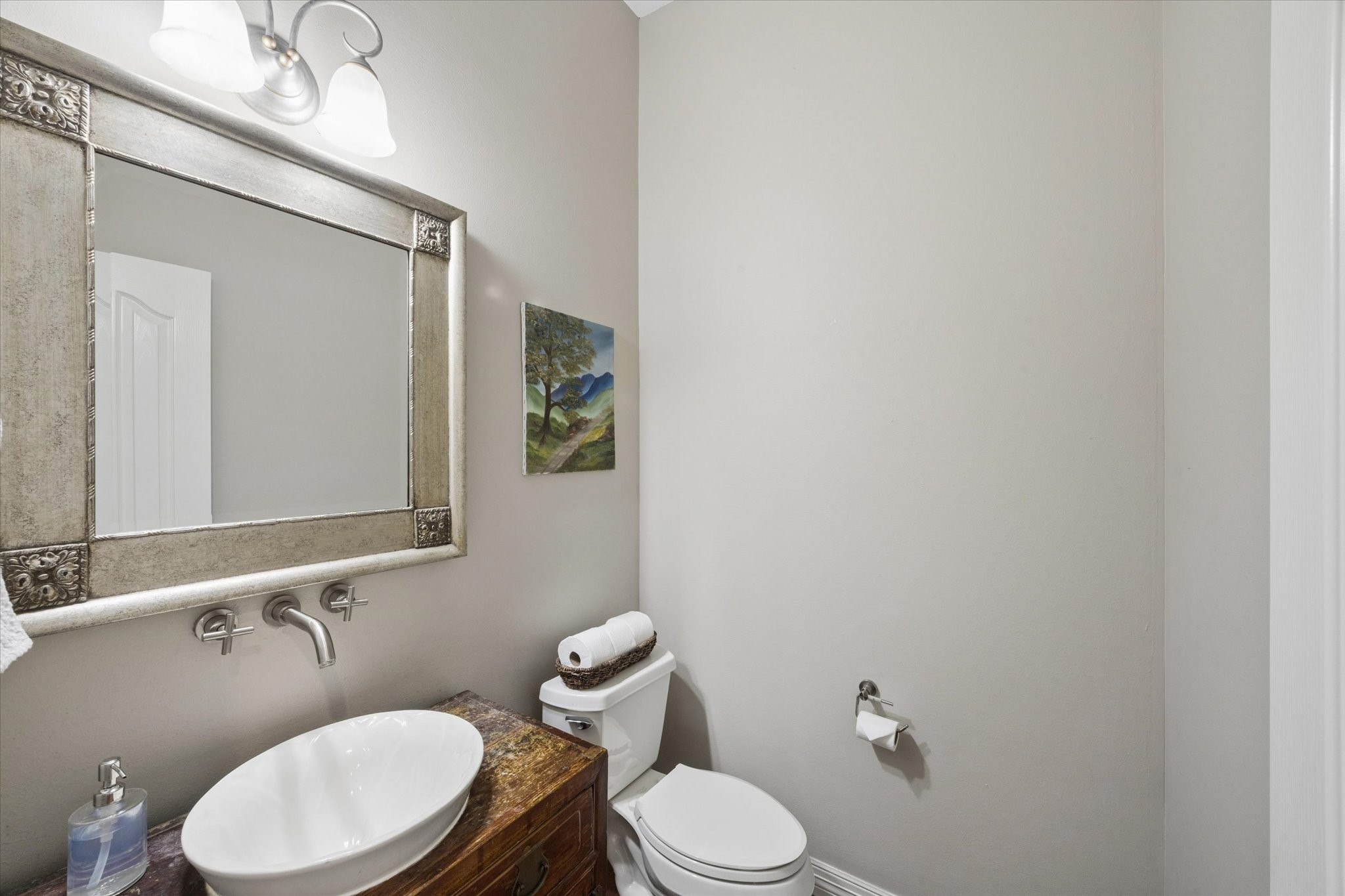 16519 Deerhaven Run Rosharon, TX 77583 - Photo 17 of 47 a white toilet sitting next to a bathroom sink and mirror