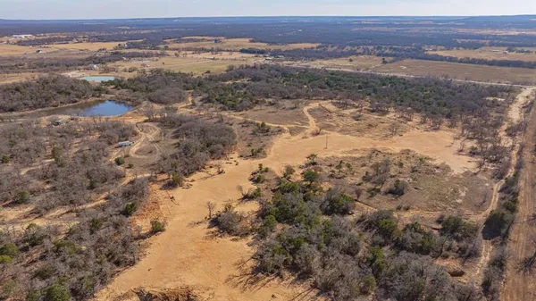 a view of a field with mountains in the background