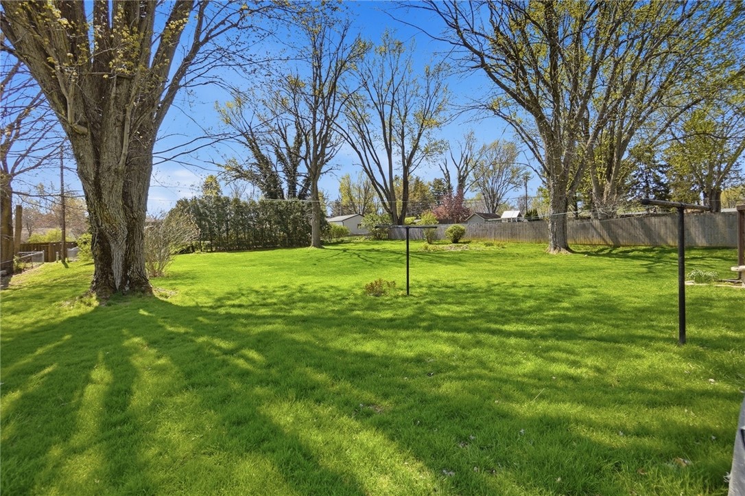 6225 Possum Run Road Bellbrook, OH 45305 - Photo 30 of 33 This lush backyard offers ample green space and mature trees for ultimate privacy.