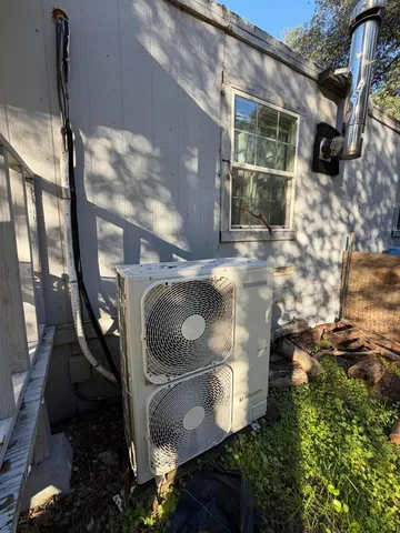a backyard of a house with outdoor seating