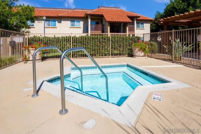 a view of a house with backyard and deck