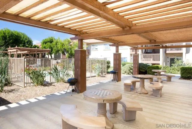 a view of a patio with chairs and potted plants