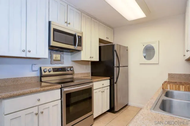 a kitchen with stainless steel appliances granite countertop a refrigerator stove and microwave
