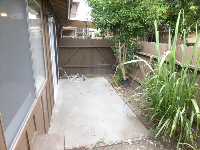a backyard of a house with table and chairs
