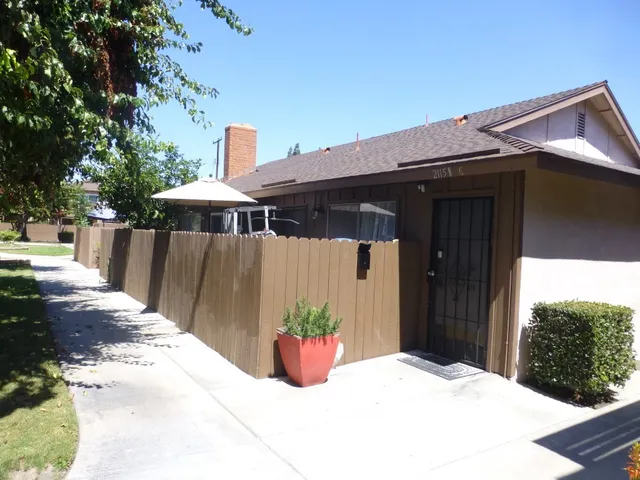 a view of a porch with furniture and barbeque grill
