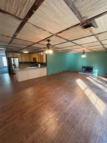 a view of a room with wooden floor