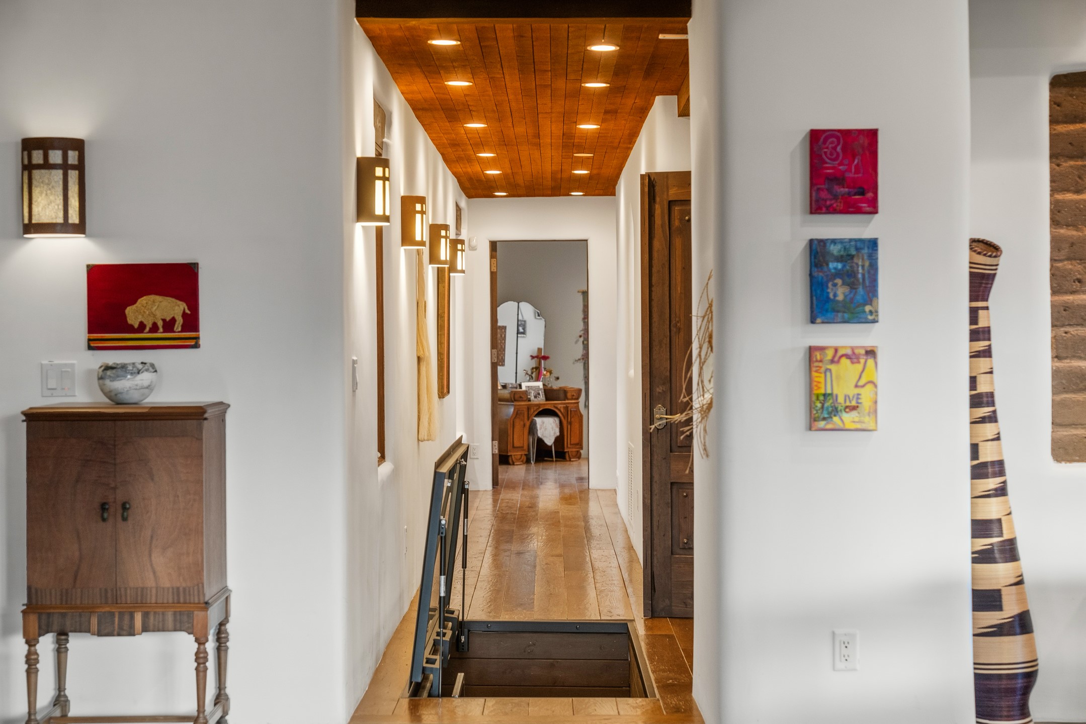 148 Barranca Road Santa Fe, NM 87501 - Photo 62 of 86 Hallway with a floor opening to the wine cellar