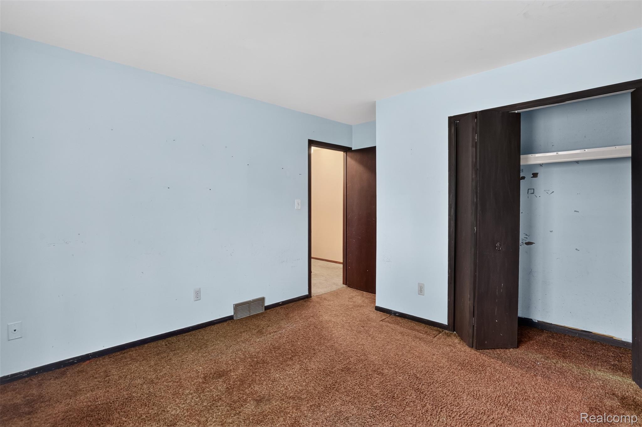 16955 English Road Manchester, MI 48158 - Photo 17 of 37 Room with light blue painted walls, brown carpet flooring, and dark trim