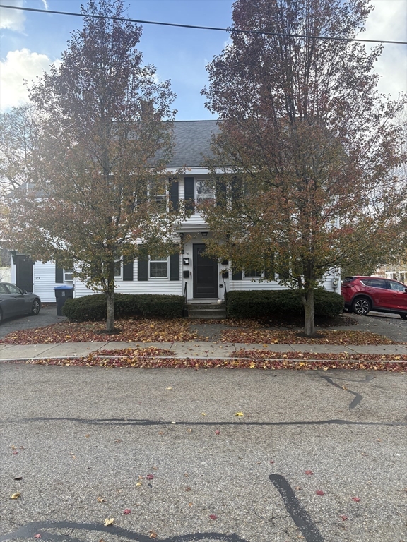 34 Walnut Street, Unit 4 Natick, MA 01760 - Photo 1 of 16 a front view of a house with a yard
