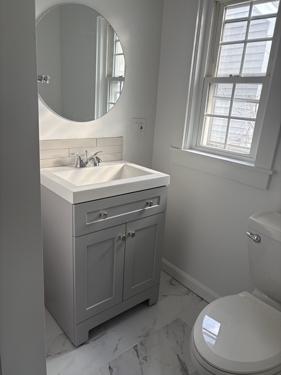 34 Walnut Street, Unit 4 Natick, MA 01760 - Photo 14 of 16 a bathroom with a toilet sink and mirror