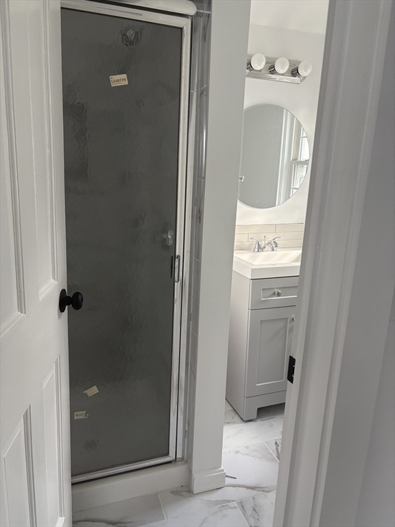34 Walnut Street, Unit 4 Natick, MA 01760 - Photo 15 of 16 a bathroom with a sink a mirror and shower