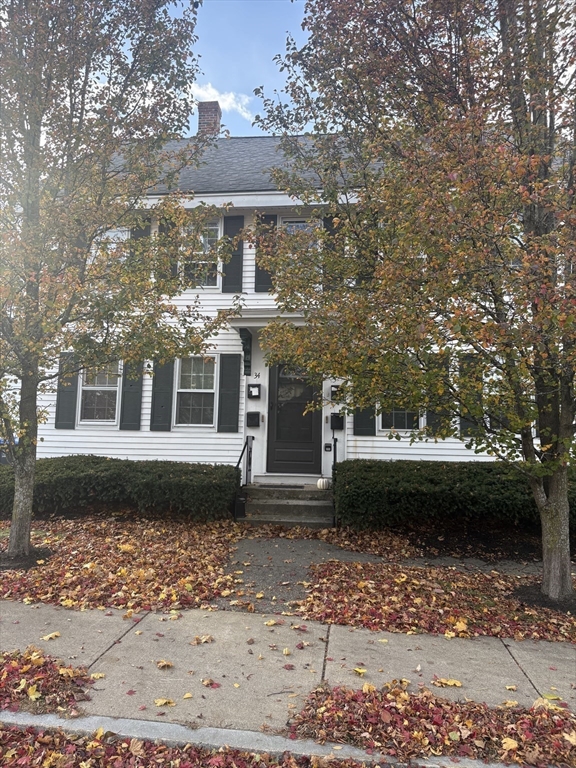 34 Walnut Street, Unit 4 Natick, MA 01760 - Photo 2 of 16 a front view of a house with a garden