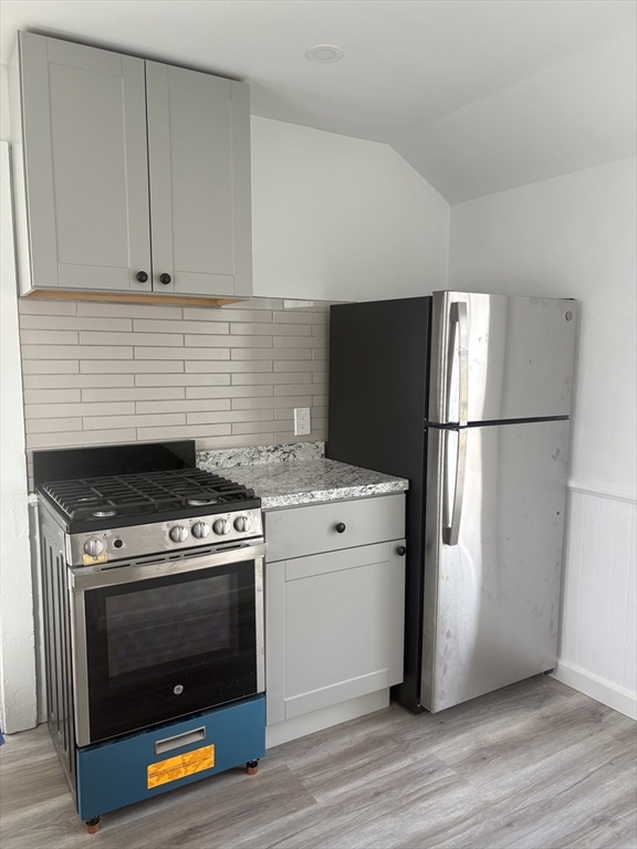 34 Walnut Street, Unit 4 Natick, MA 01760 - Photo 5 of 16 a kitchen with a stove and a refrigerator