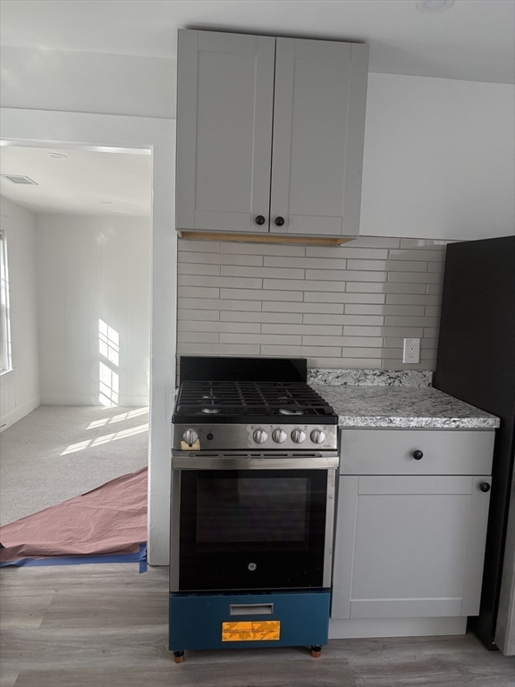 34 Walnut Street, Unit 4 Natick, MA 01760 - Photo 6 of 16 a stove top oven sitting inside of a kitchen