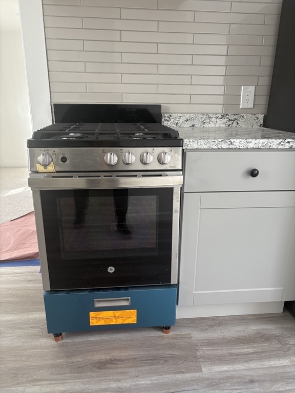 34 Walnut Street, Unit 4 Natick, MA 01760 - Photo 7 of 16 a stove top oven sitting inside of a kitchen