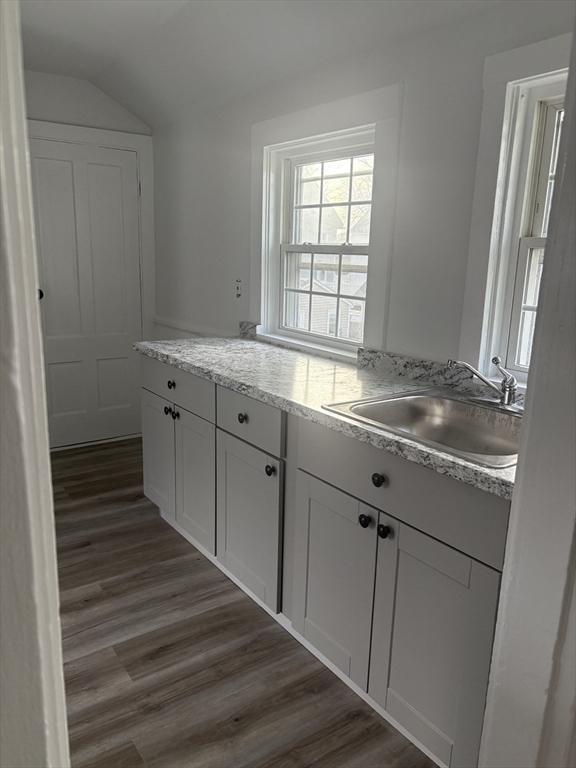 34 Walnut Street, Unit 4 Natick, MA 01760 - Photo 8 of 16 a kitchen with granite countertop a sink and a window