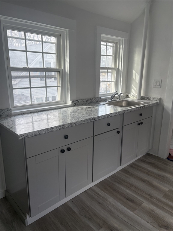 34 Walnut Street, Unit 4 Natick, MA 01760 - Photo 9 of 16 a bathroom with a granite countertop sink and window