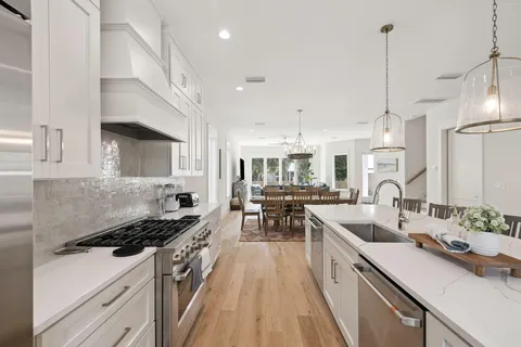 a kitchen with kitchen island granite countertop lots of counter top space and stainless steel appliances